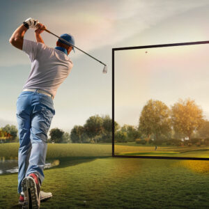 Man swinging a golf club with a screen on the background showing the golf course.
