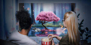 Two friends watching a movie on a projector and eating popcorn.